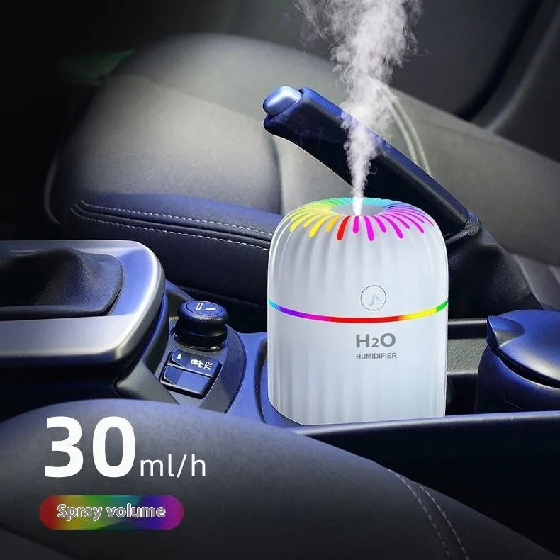 Mini green animal-shaped USB humidifier for car or desk use with cable.