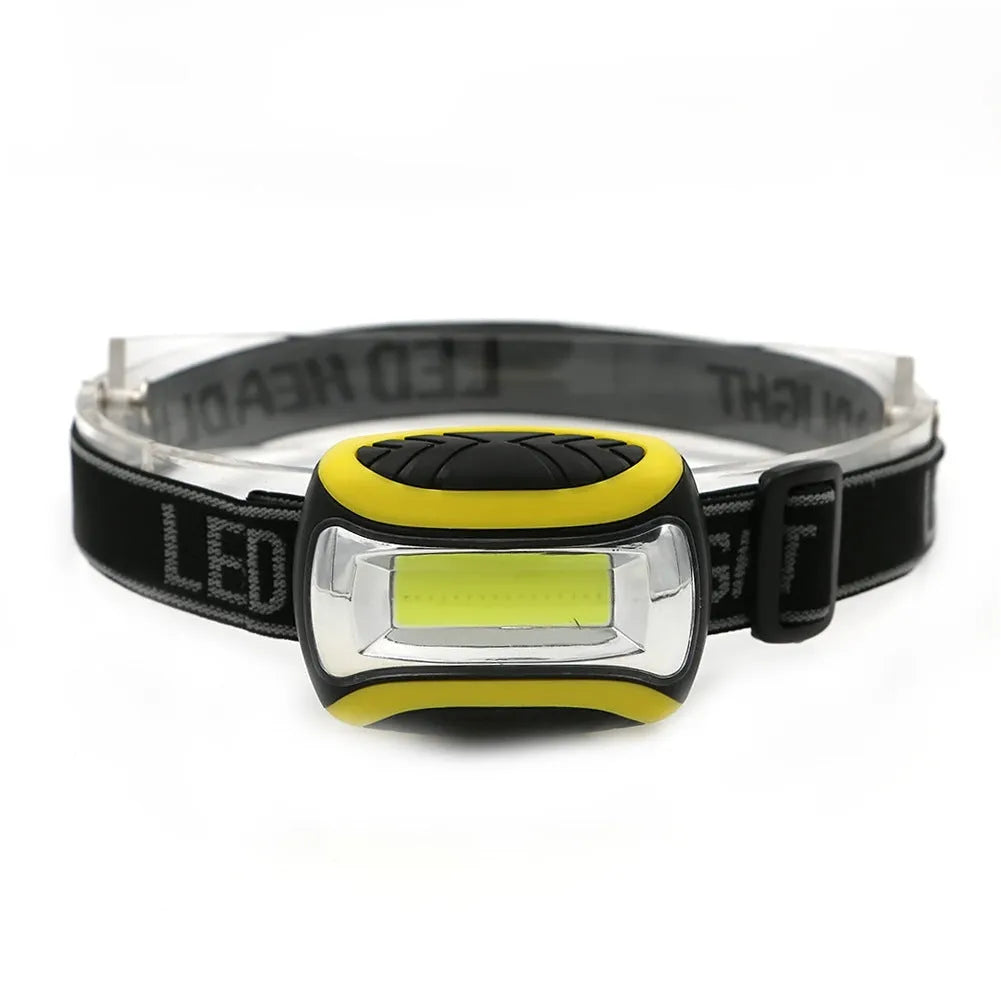 Yellow plastic headlamp with COB LED light and adjustable elastic head strap.