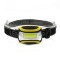 Yellow plastic headlamp with COB LED light and adjustable elastic head strap.