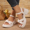 Women's black thick-heel slippers with a decorative skirt detail and button fastening.