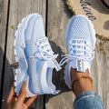 Women's Flyknit mesh lace-up sneakers in a grey colourway showing round toe and low profile.