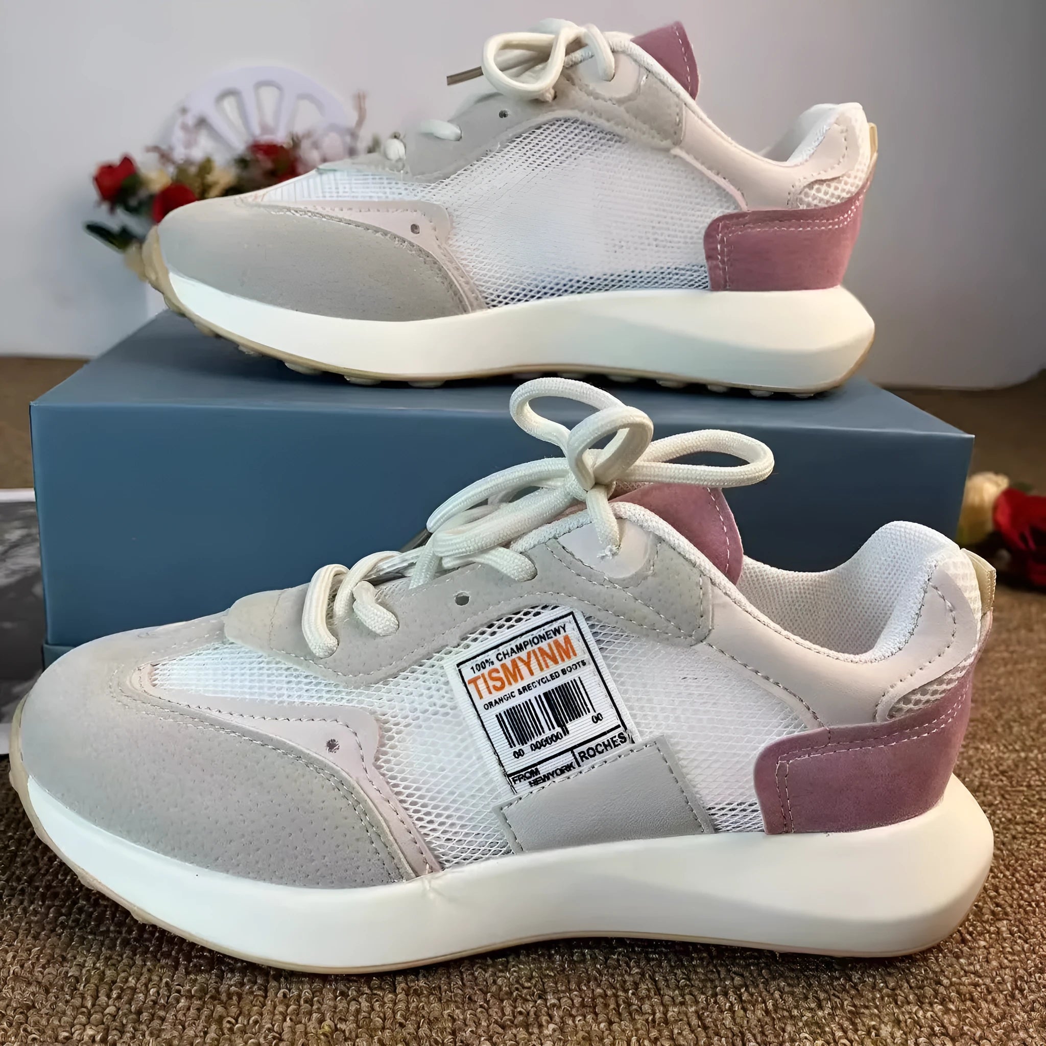 Women's pink and grey retro low-top sneaker with round toe and flat rubber sole.