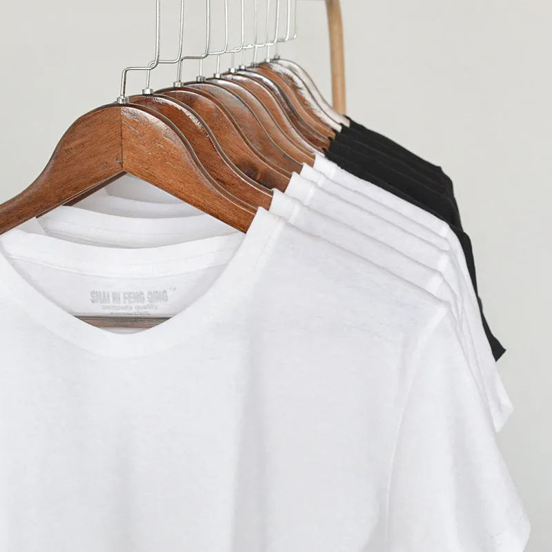 Men's solid colour round neck cotton t-shirt on a hanger, showing short sleeves and casual fit.