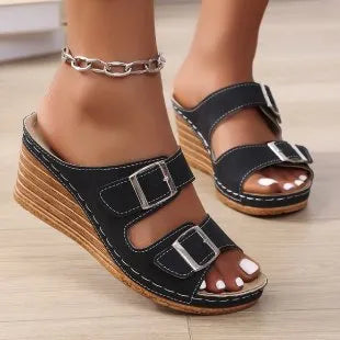 Women's creamy-white wedge buckle slippers with PU upper and rubber sole on a plain background.