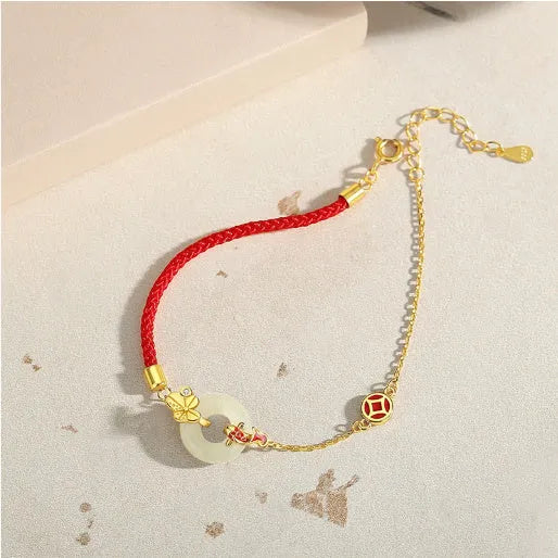 Women's 925 silver bracelet with gold electroplated peace buckle, koi fish charm, and adjustable red rope.