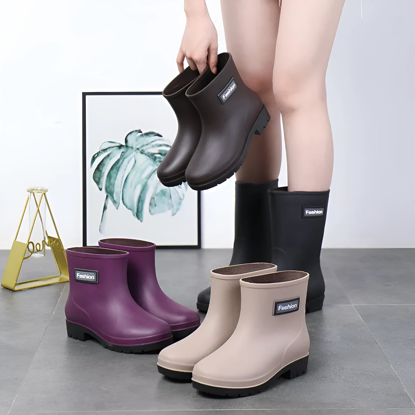 Women's PVC rain boots in black with mid-calf height and low heel design