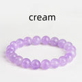 Light purple amethyst crystal bracelet with round beads and water ripple design on a wrist.