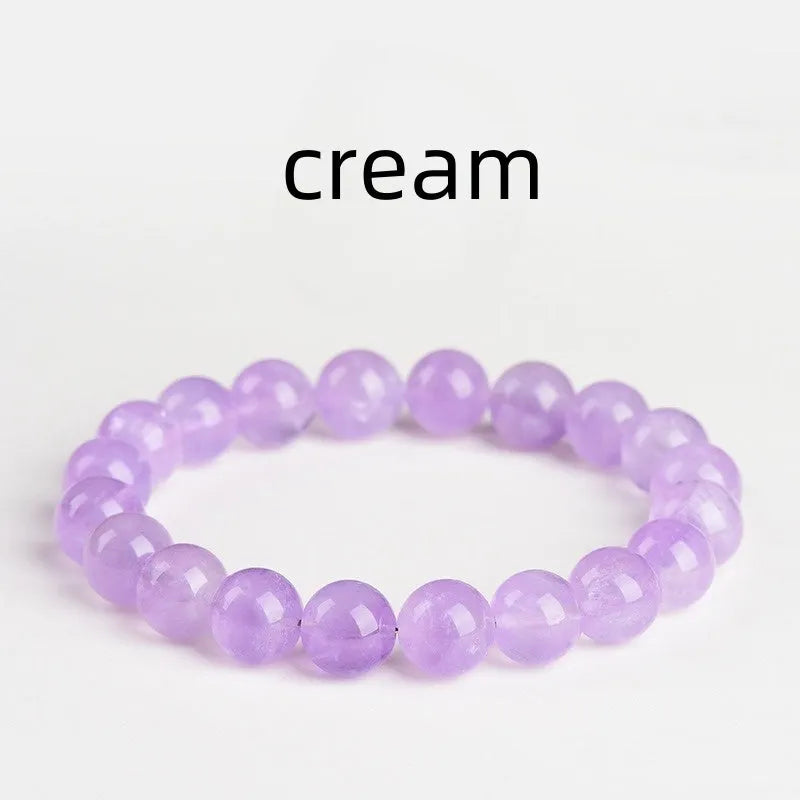 Light purple amethyst crystal bracelet with round beads and water ripple design on a wrist.
