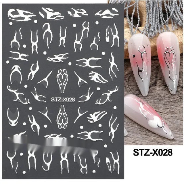 Set of 60 black and silver cartoon pattern nail strip stickers with plastic application patch.