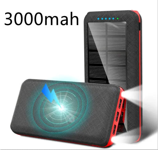 Black portable solar power bank with wireless charging pad and three USB ports on a wooden surface.