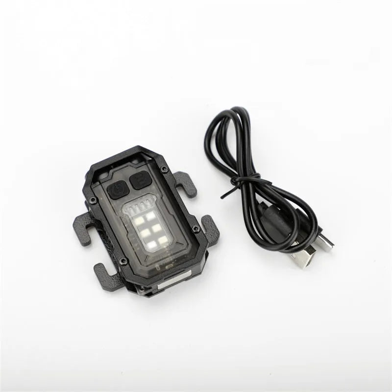 Compact black tactical warning flashlight with a USB charging cable and a clip for backpack mounting.