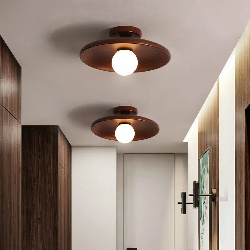 Solid wood ring ceiling lamp with glass shade in modern minimalist design.