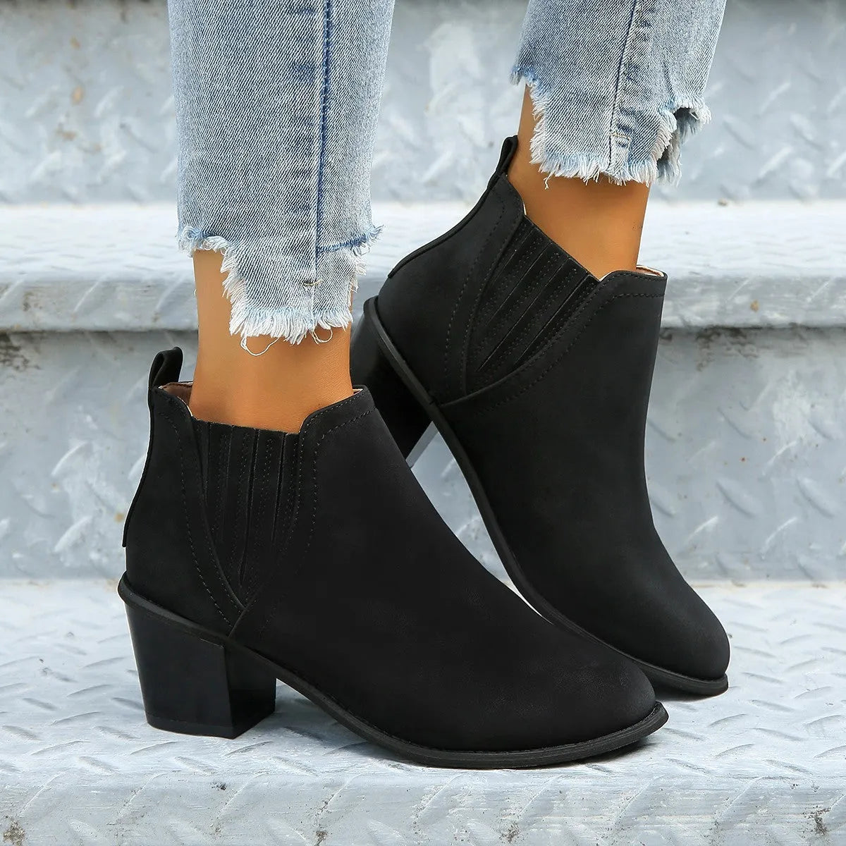 Women's black pointed toe ankle boots with thick square low heel slip-on design