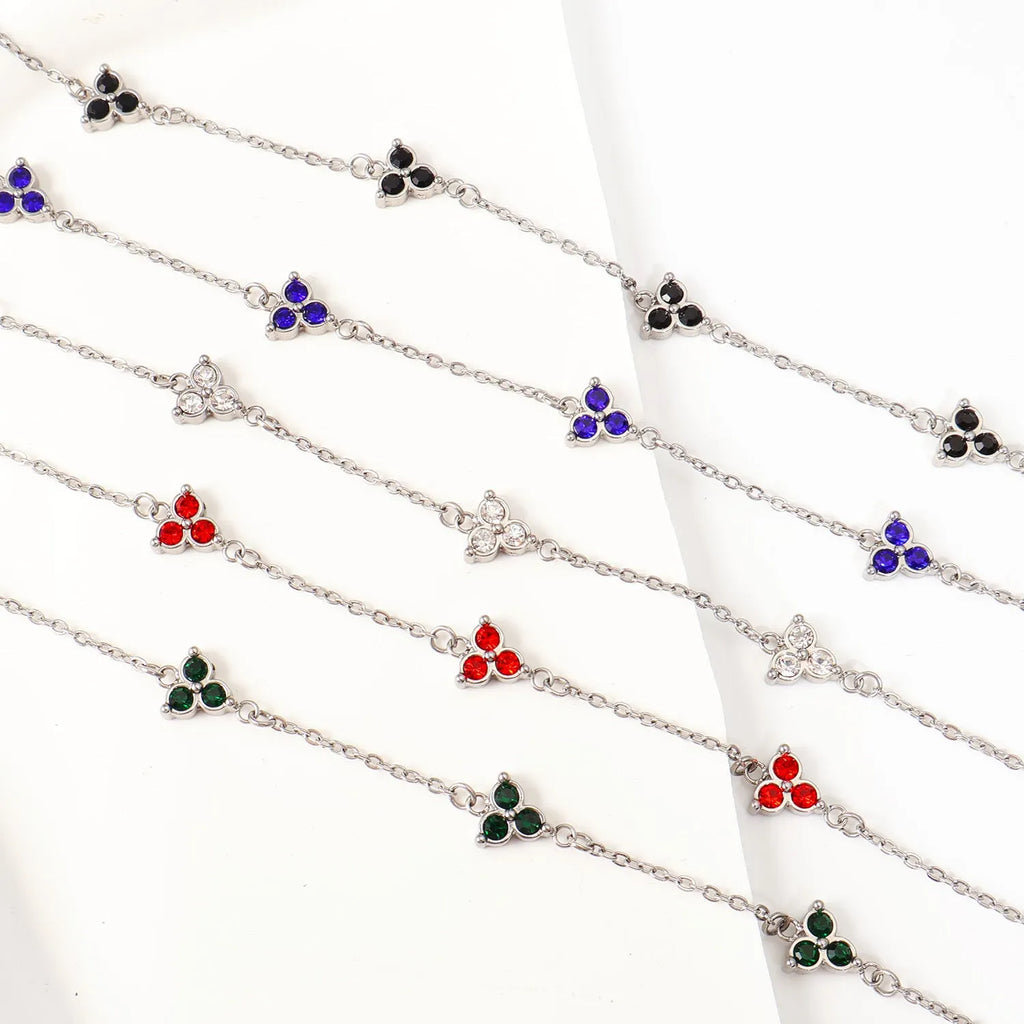 Women's geometric stainless steel bracelet with triangular diamond elements in gold or steel finish with coloured stones.