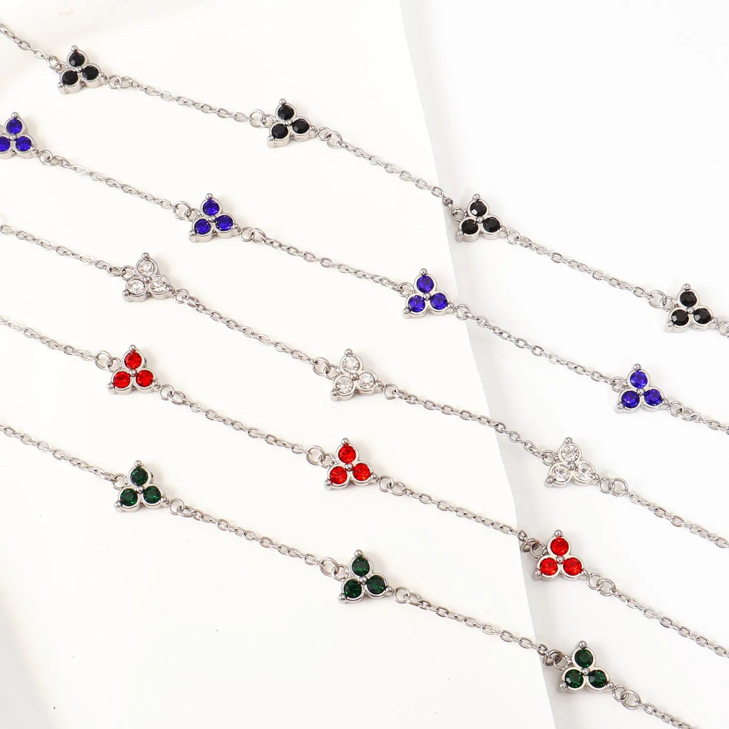 Women's geometric stainless steel bracelet with triangular diamond elements in gold or steel finish with coloured stones.
