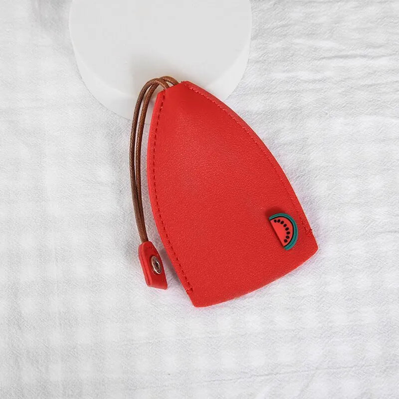 Colourful cartoon pull-out key protector case made from PU leather, showing a selection of fruit and animal designs.