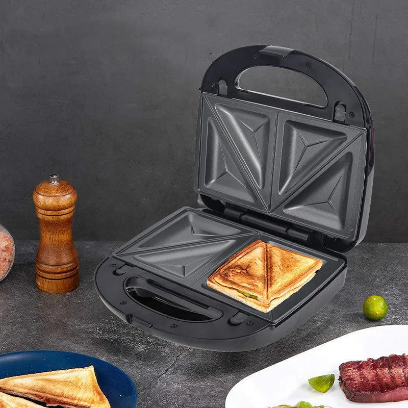Black electric sandwich pan with brushed stainless steel top cover and exchangeable non-stick baking pans