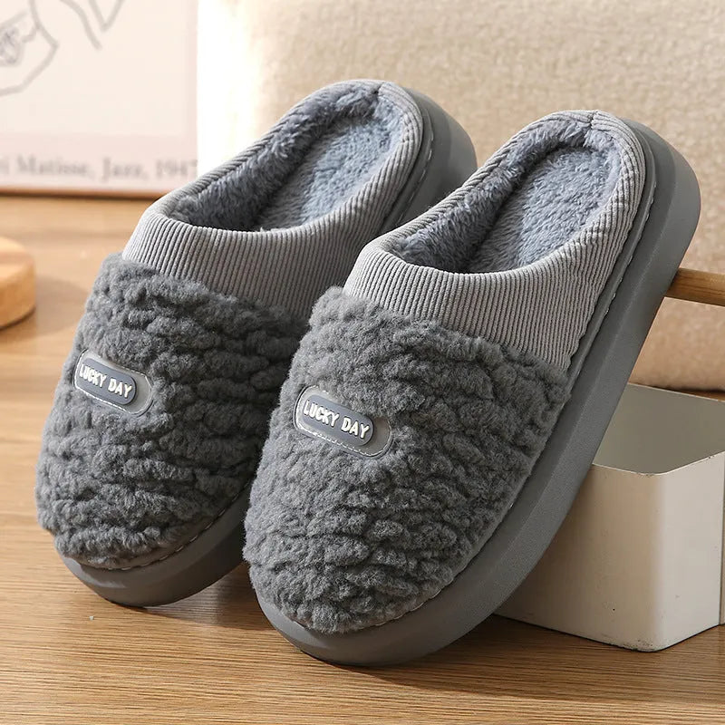 Men's grey plaid slippers with rabbit hair upper and EVA sole, showing toe holder design