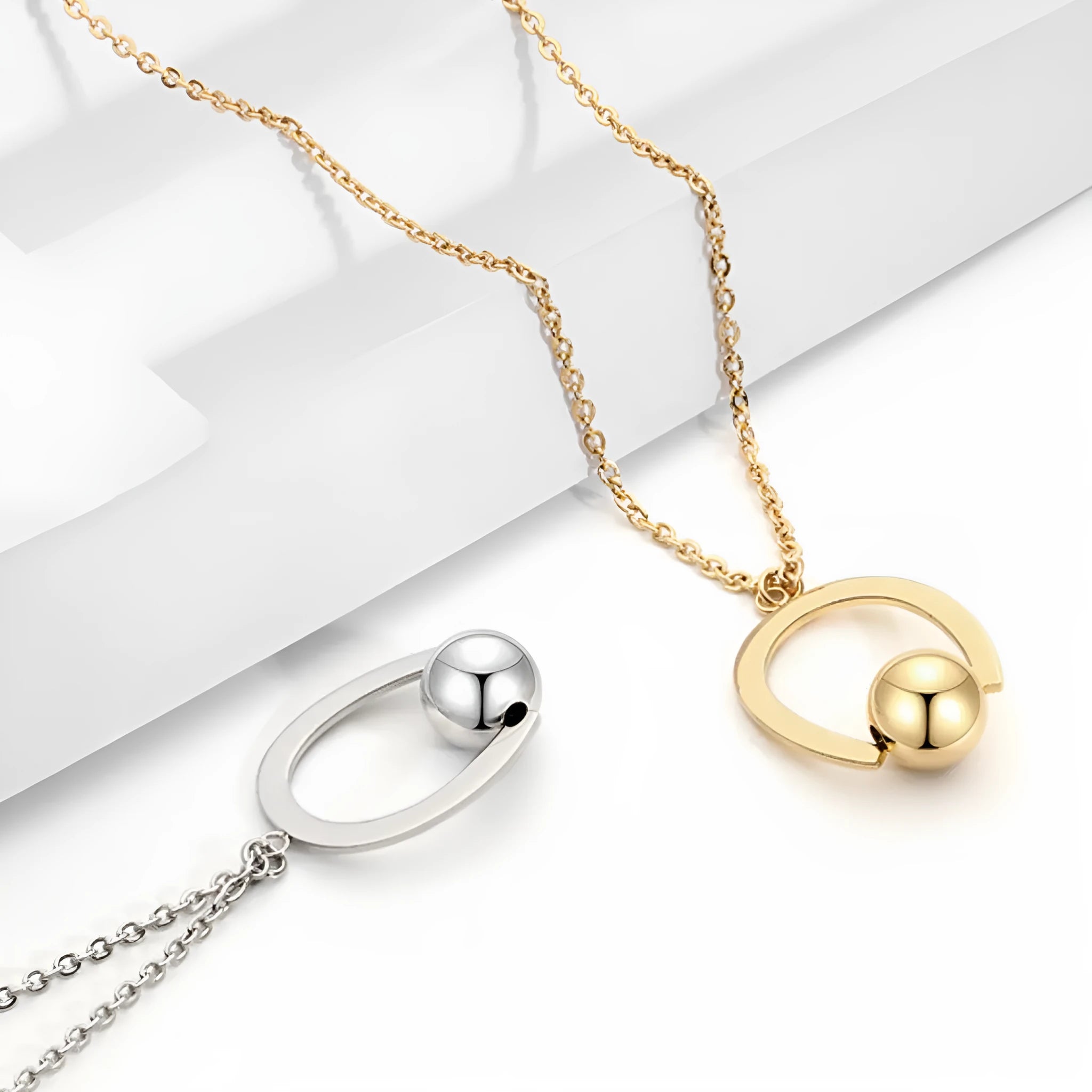 Stainless steel cross chain necklace with geometric pendant in gold or silver electroplated finish
