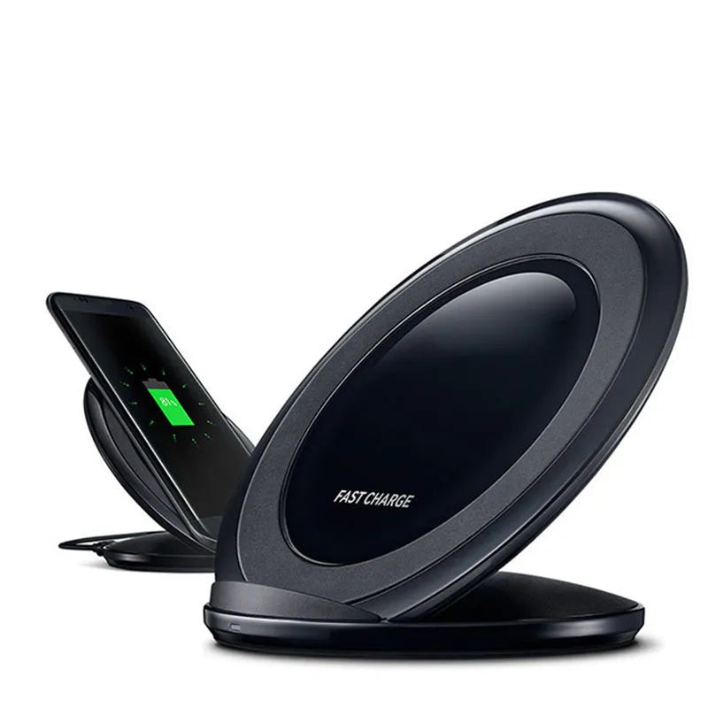 Black Qi wireless charging pad for Samsung Galaxy Note Edge on a wooden surface