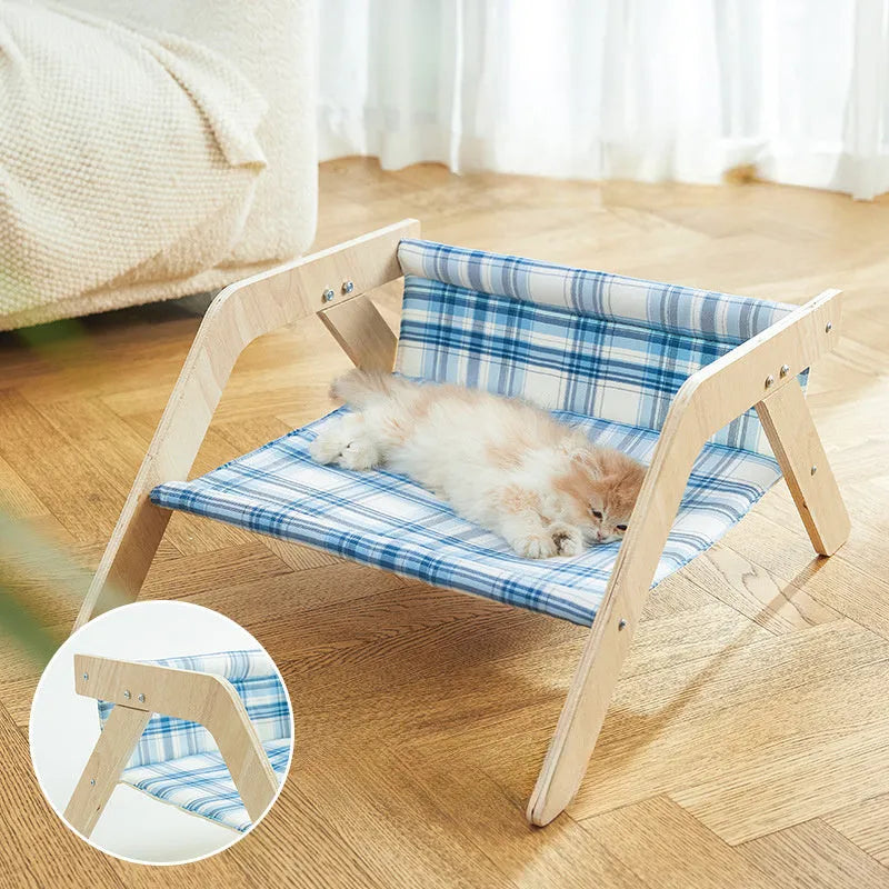 Wooden frame cat hammock bed with soft blue cloth on a wooden beach chair structure