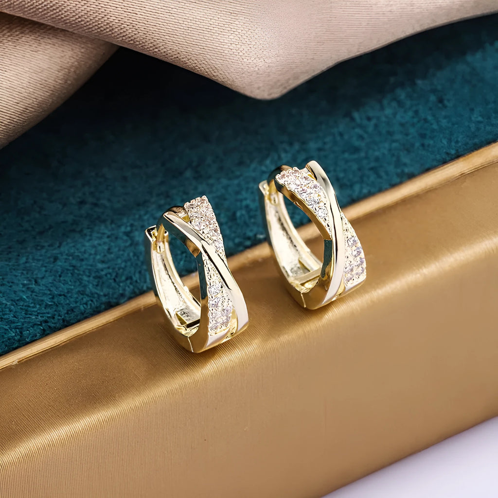 A pair of geometric-shaped copper earrings with a zircon-treated 14K yellow finish.