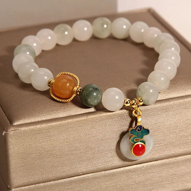 Women's ice jade crystal bracelet with a pearl detail and traditional Chinese jade buckle.