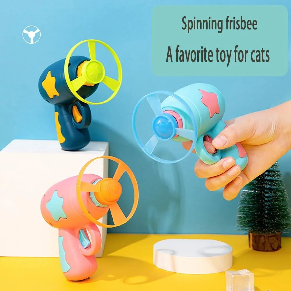 Blue interactive cat toy gun with plastic frisbee on launch mechanism for indoor feline play