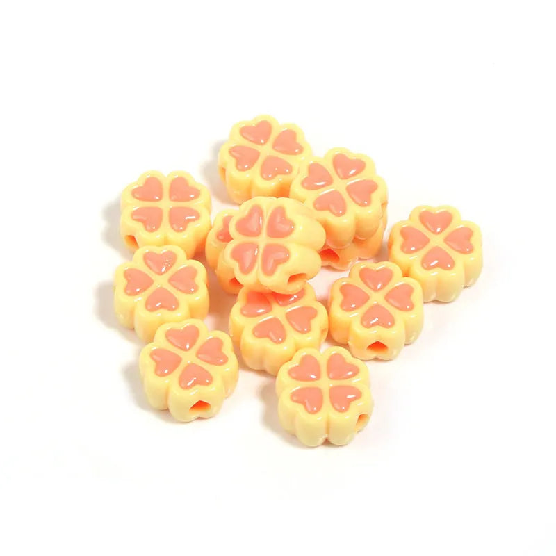 Mixed colour frosted acrylic four-leaf clover shaped beads, each 15mm in size.