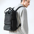 Black Oxford cloth laptop backpack showing 20-35L capacity and lightweight design.