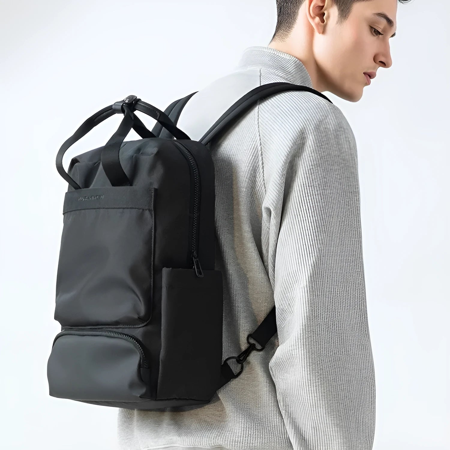 Black Oxford cloth laptop backpack showing 20-35L capacity and lightweight design.