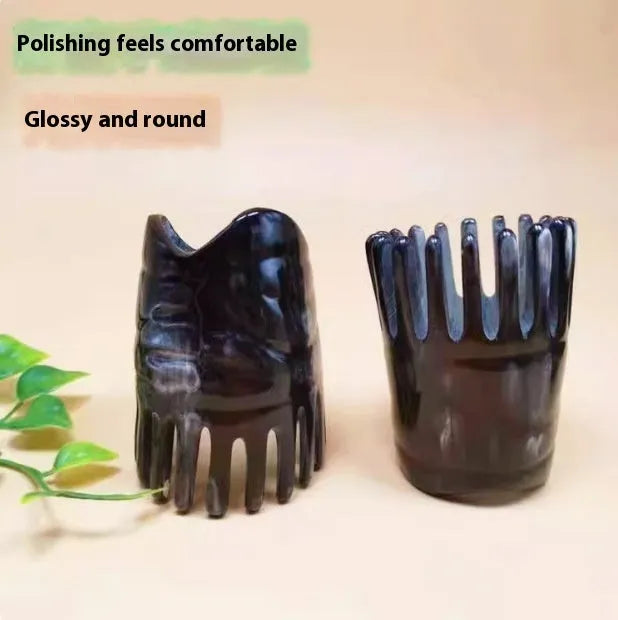Black buffalo horn comb with wide teeth and pointed tips for scalp massage