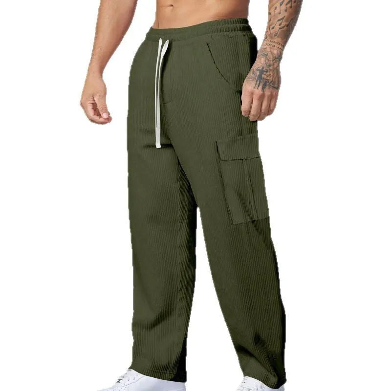 Men's navy blue corduroy cargo trousers with wide-leg design and drawstring waist laid flat.