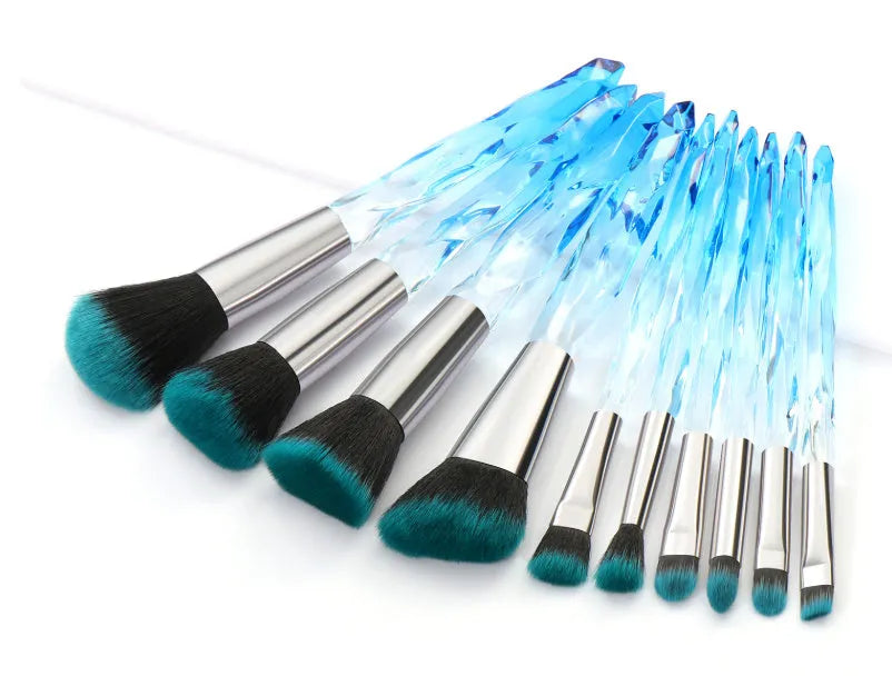 Ten clear crystal-handled foundation brushes with artificial fibre bristles in black, blue, red, and yellow colours