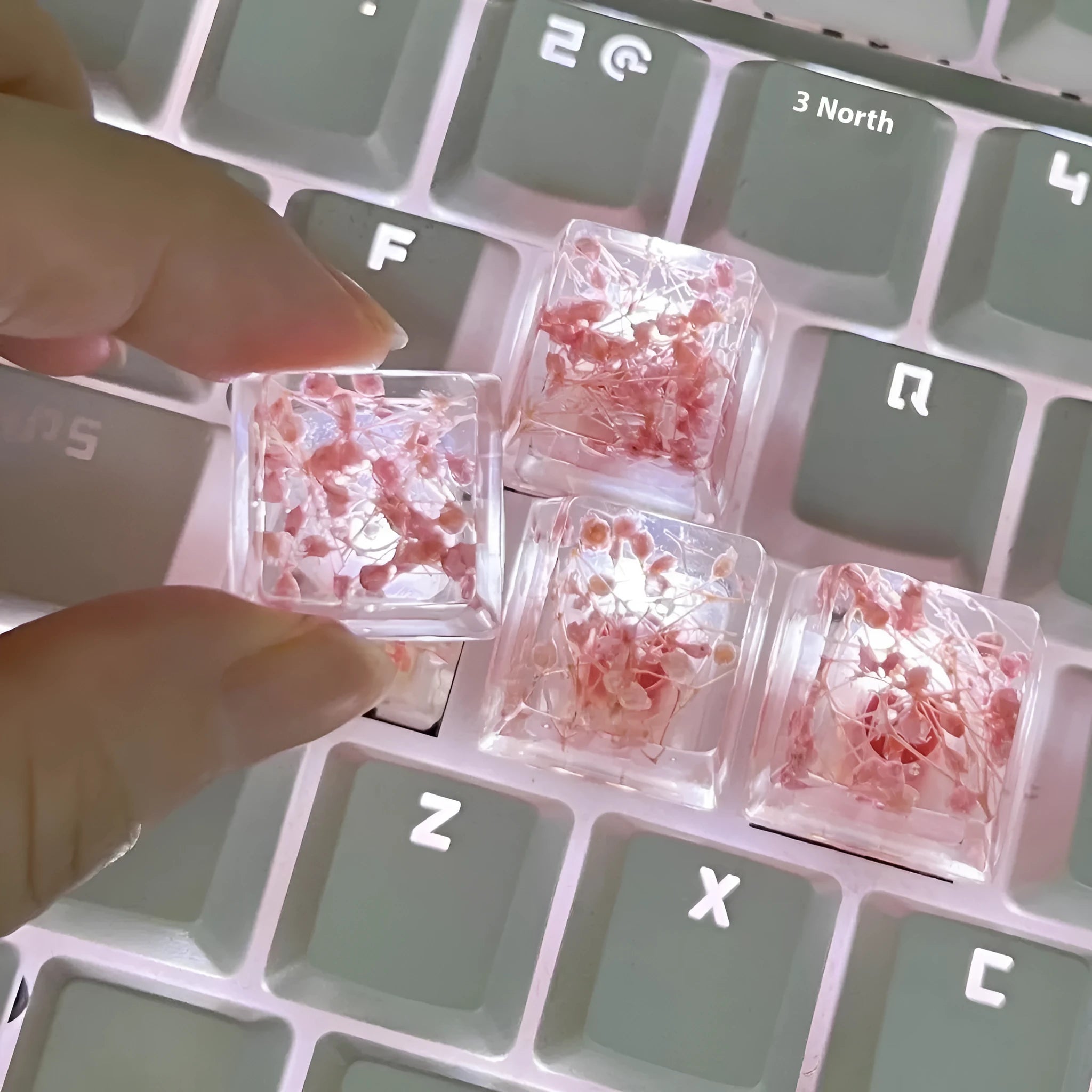 Green resin transparent keycap with glitter starry sky design for mechanical keyboards.