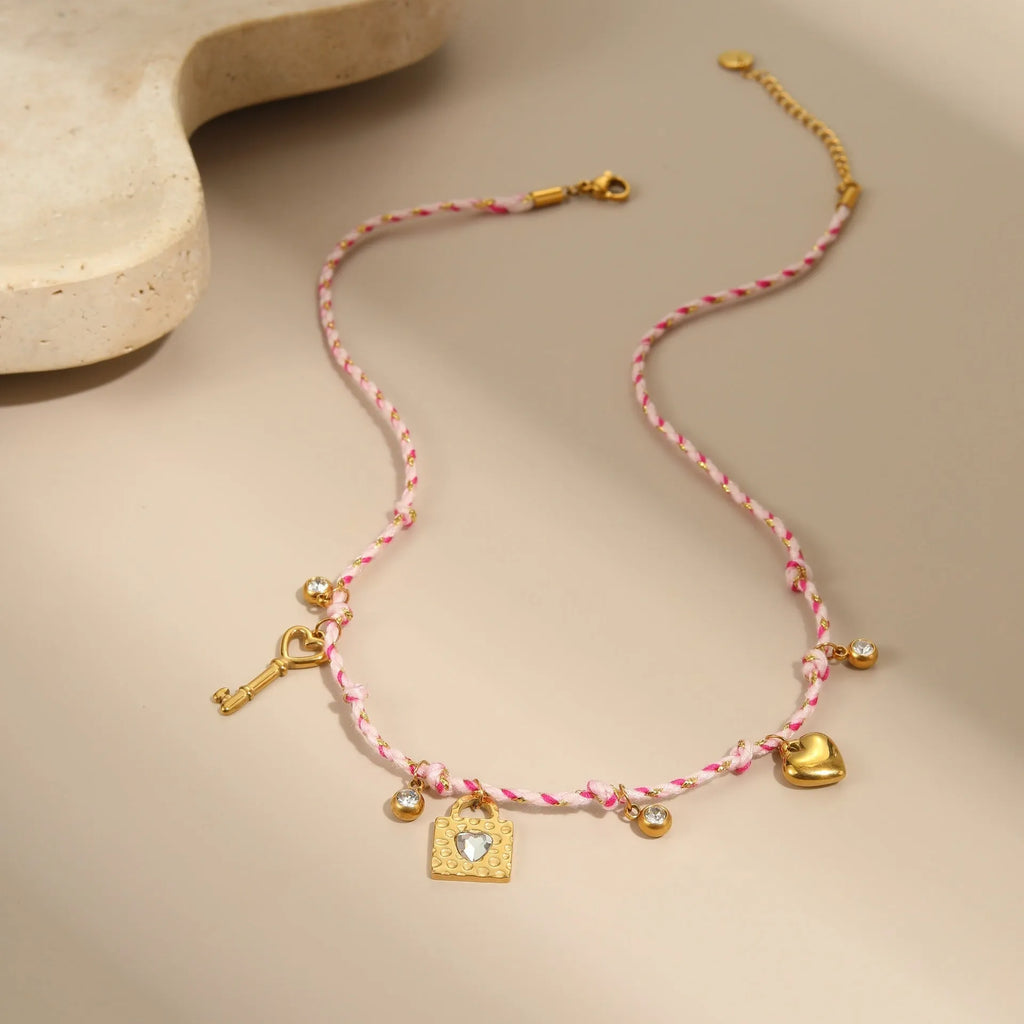 Handmade colour braided rope and stainless steel necklace with heart-shaped pendant on adjustable chain.