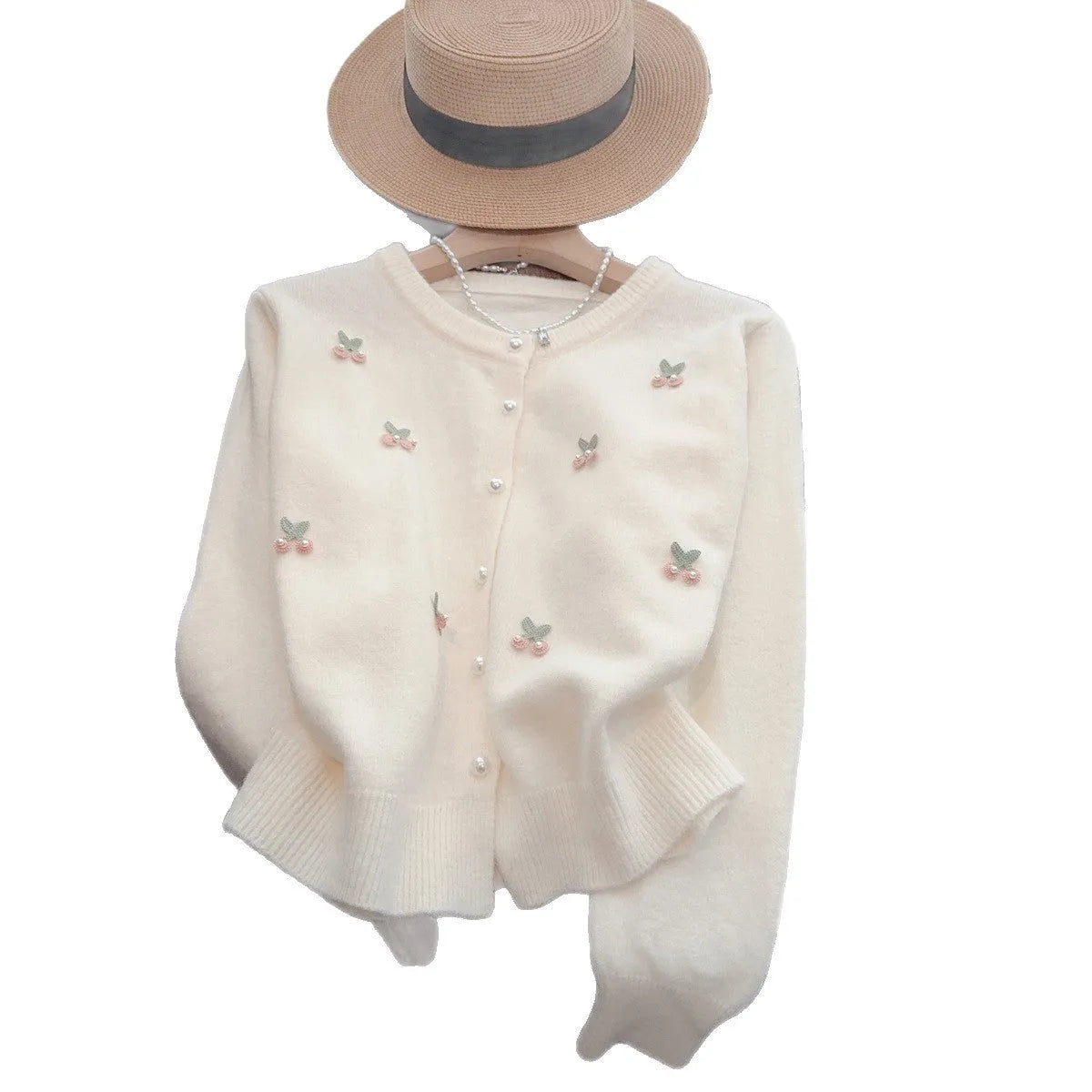 A pink cashmere blend women's cardigan sweater coat with beaded detailing and a round neck, shown open.