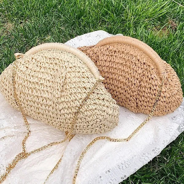 Shell-shaped straw shoulder bag with chain detailing and internal zipper pocket
