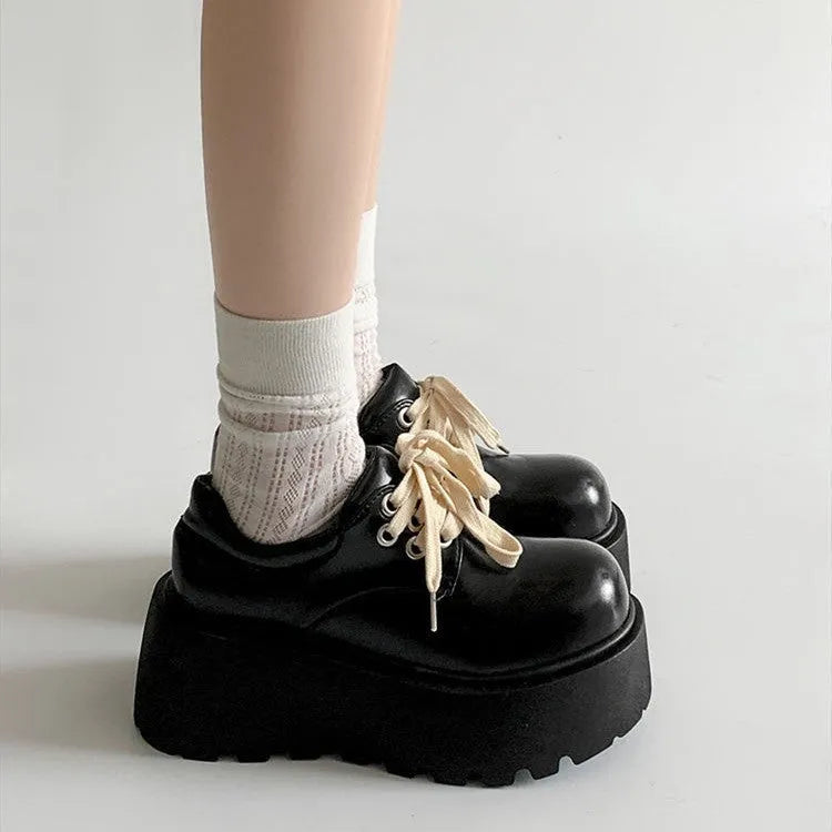 Matte black women's lace-up platform heels with chunky 6-8cm sole and round toe.