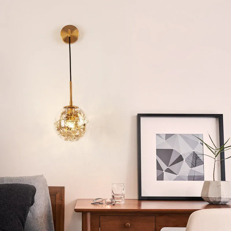 Modern glass wall lamp with golden flower pattern, 20cm size, emitting warm LED light.