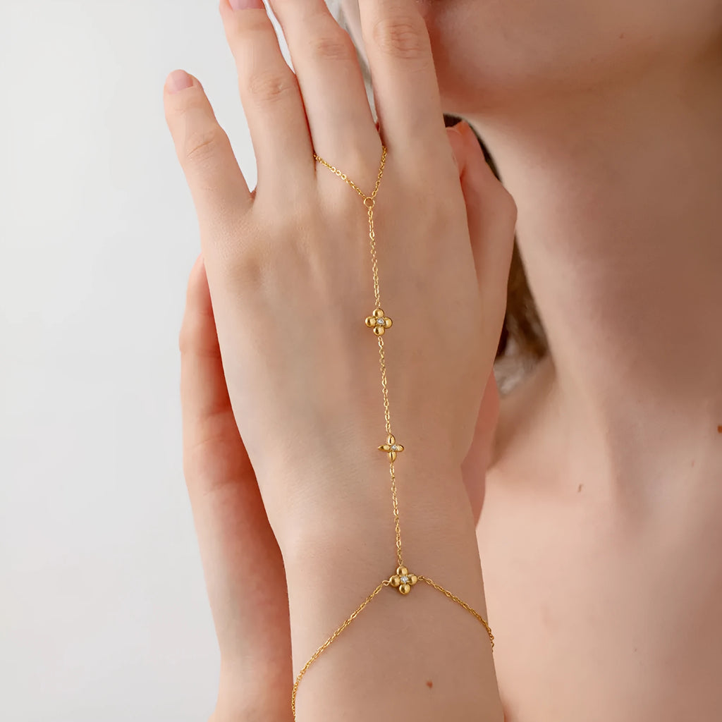 Gold geometric women's bracelet with floral and eight-pointed star design elements