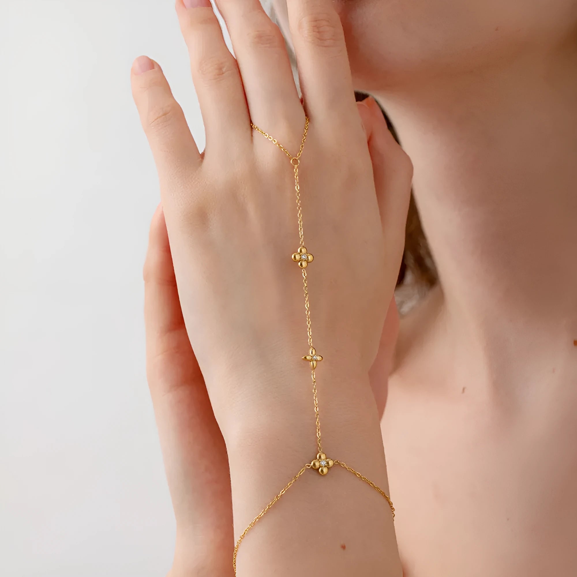 Gold geometric women's bracelet with floral and eight-pointed star design elements