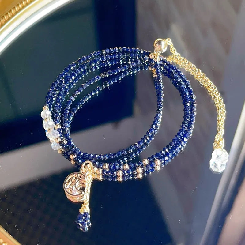 Women's three-ring bracelet with blue sand stone beads in multi-layered gold-tone design