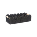 Modern weaved paper storage basket in khaki holding remote controls and stationery on a desktop