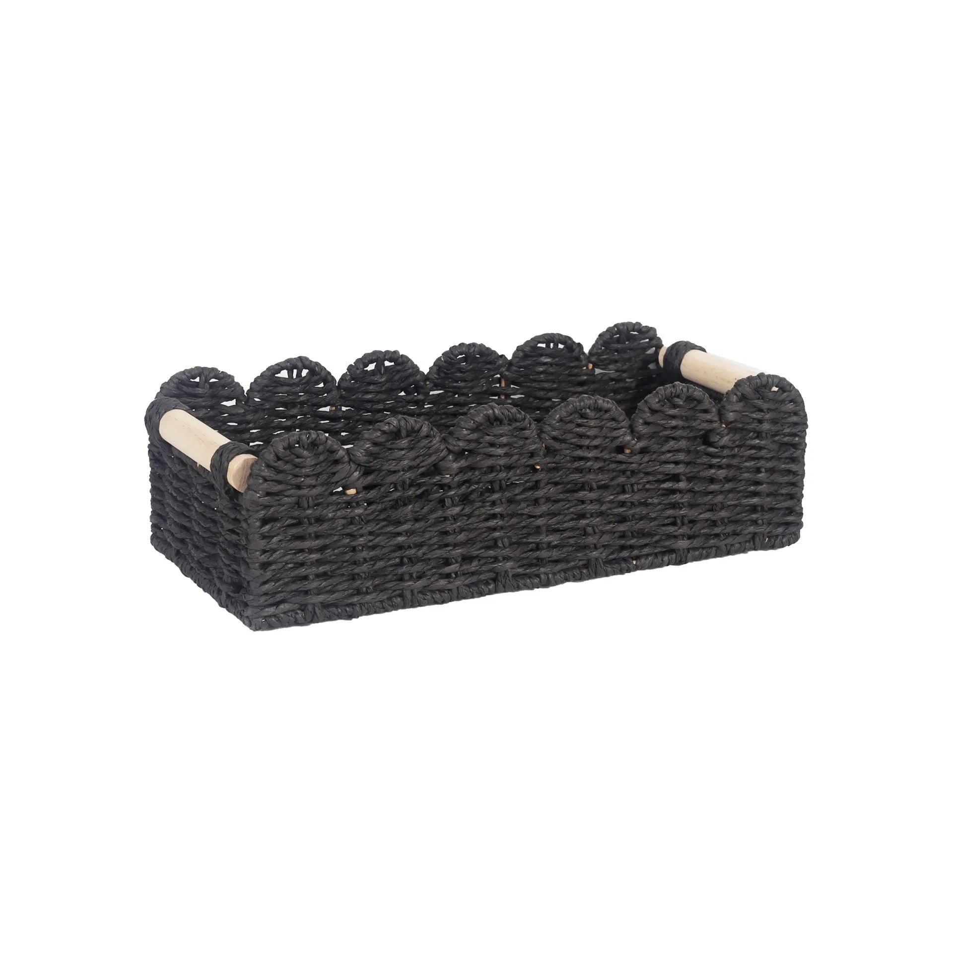 Modern weaved paper storage basket in khaki holding remote controls and stationery on a desktop