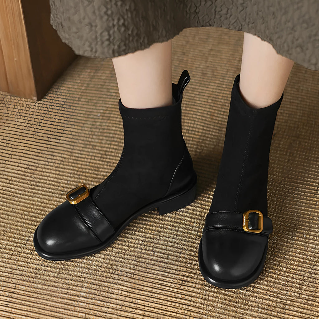 Women's black low-heel Martin boots with lace-up front and decorative belt buckle stitching.
