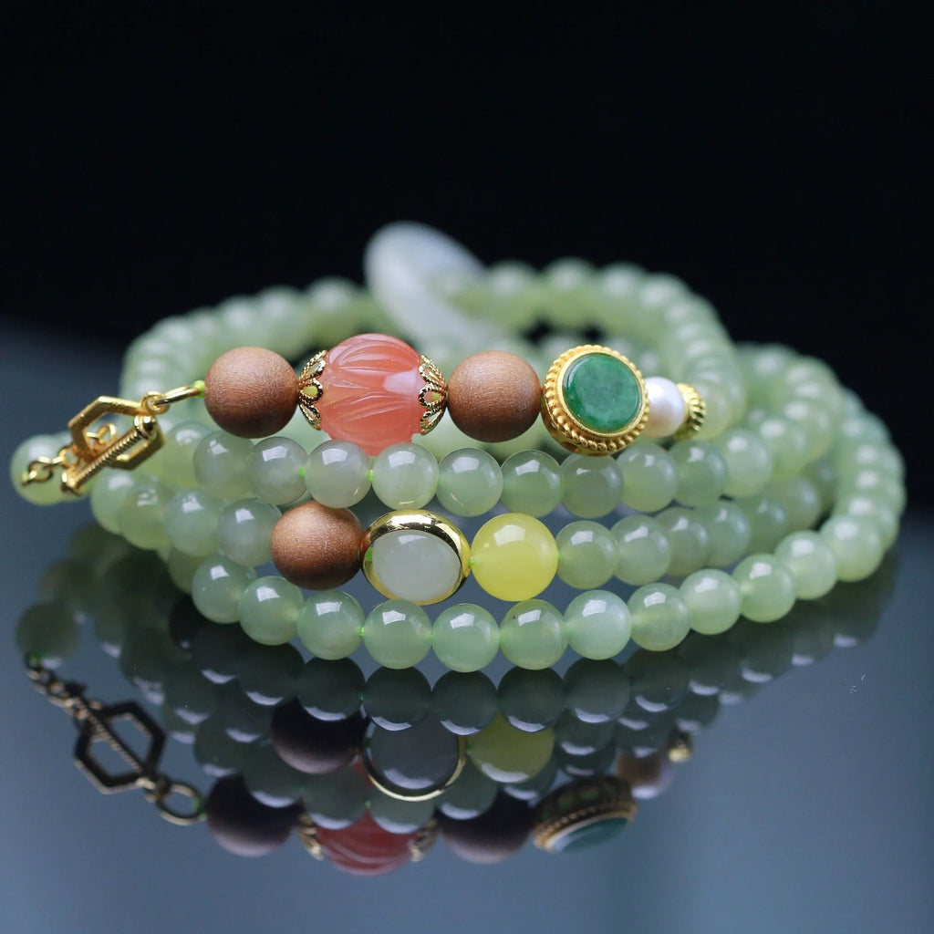 Natural Hetian jade necklace with red lotus beads, white sandalwood, and beeswax accents; unisex design with fu character motif