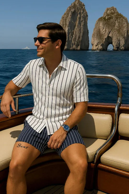 Men's blue beach shirt and shorts set on a hanger