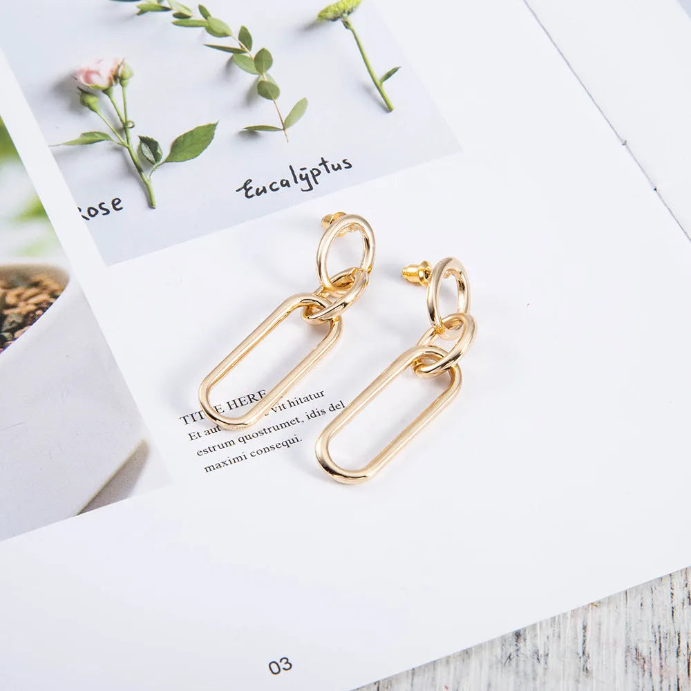 Geometric sterling silver needle hoop earrings with ring and line design details