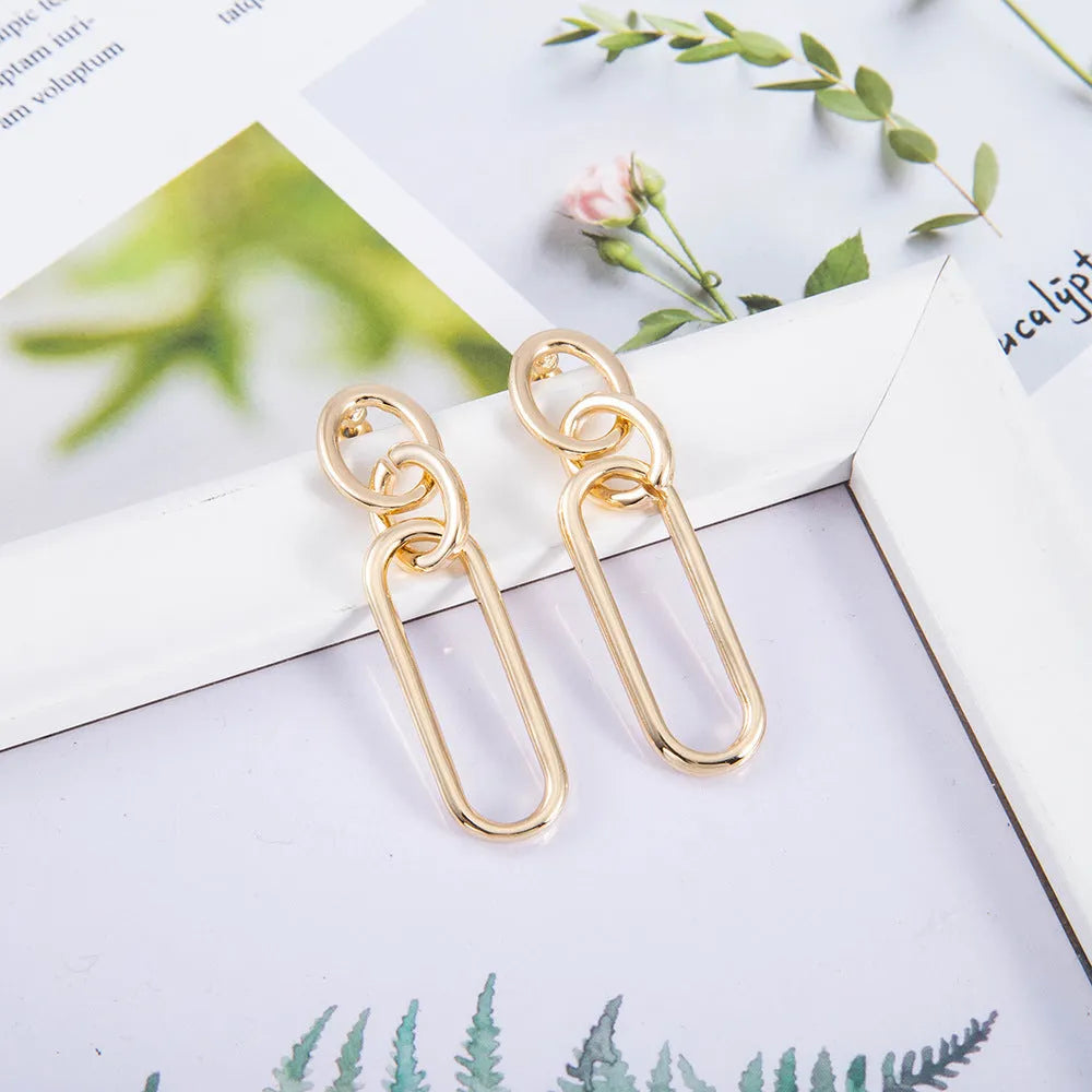Geometric sterling silver needle hoop earrings with ring and line design details